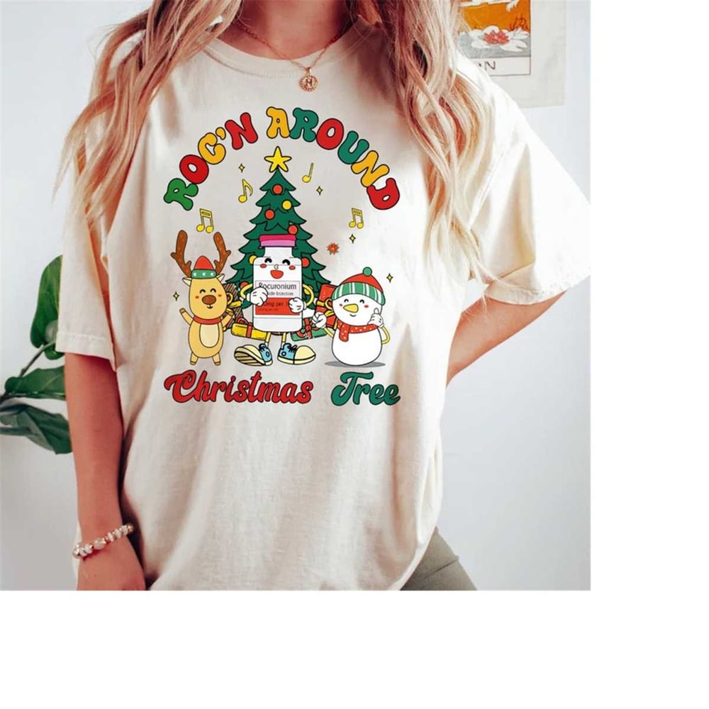 MR-16102023113155-christmas-nurse-rocn-around-the-christmas-tree-t-shirt-image-1.jpg