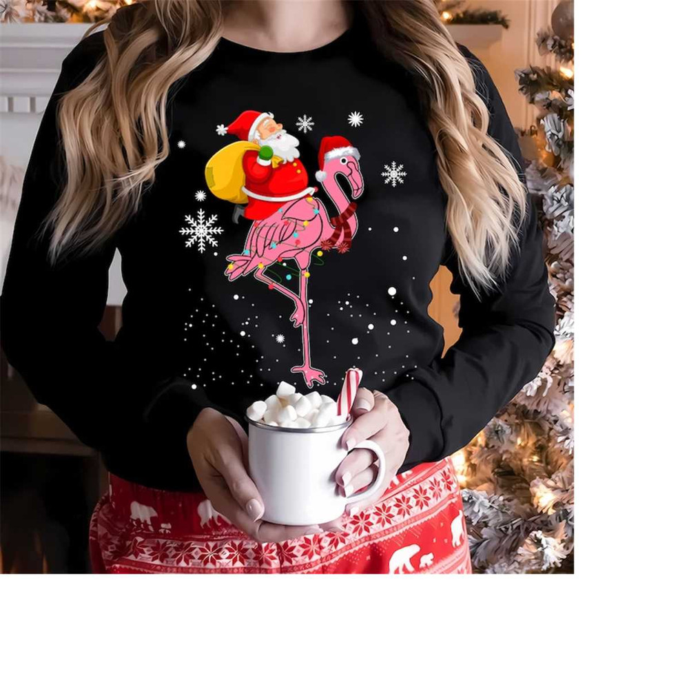 MR-26102023144356-santa-claus-riding-pink-flamingo-t-shirtflamingo-christmas-image-1.jpg