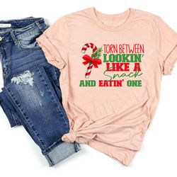 torn between lookin' like a snack and eatin' one shirt, christmas candy shirt, candy cane t-shirt, xmas holiday shirt, x