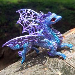 lilac dragon with openwork wings. purple, light purple running dragon.