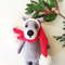 Small gray wolf toy in santa cap