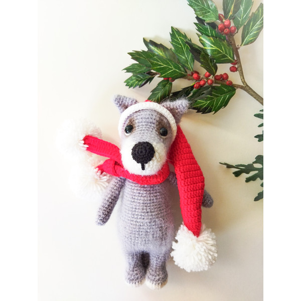Small gray wolf toy in santa cap