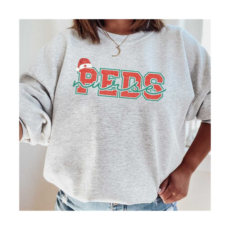 13112023101348-peds-christmas-nurse-varsity-png-pediatric-nurse-retro-xmas-image-1.jpg