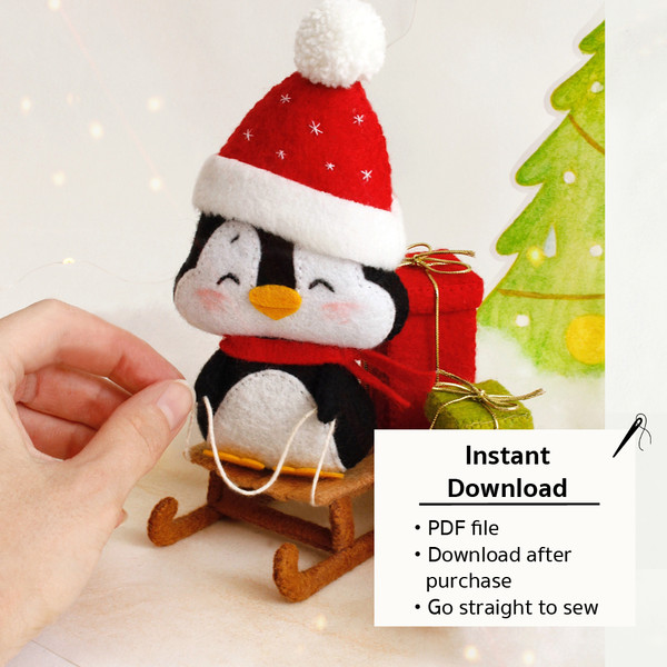 Felt penguin on the sleigh with Christmas presents in the author's hands and information about the PDF tutorial with patterns