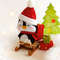 Felt penguin on the sleigh with Christmas presents, side view