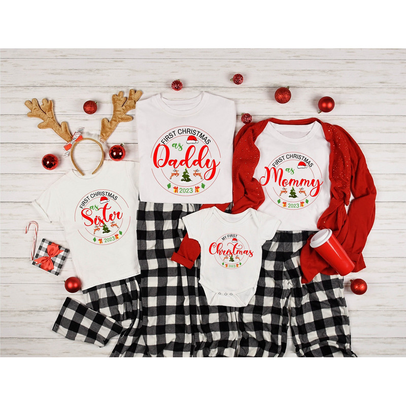 Family's First Christmas 2023 Shirt, Our First Christmas Together 2023 T-Shirts, First Xmas As Mom And Dad Tees, Christmas Baby Announcement.jpg