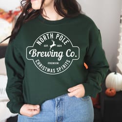 north pole brewing co sweatshirt, christmas sweatshirt, premium christmas spirit, brewing co sweatshirt, north pole swea