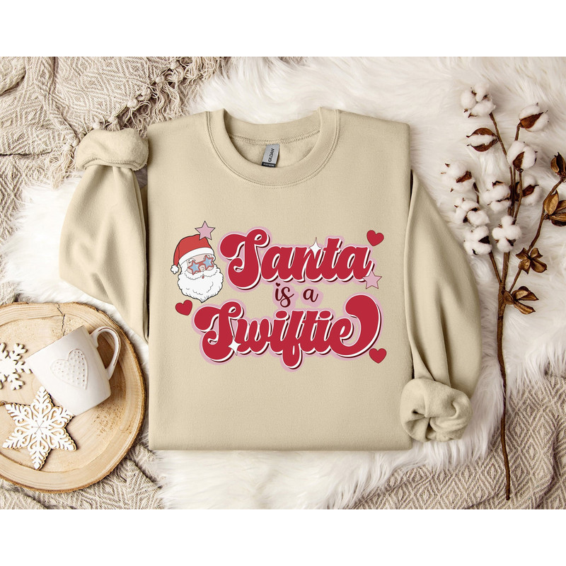 Taylor Swiftie Christmas Sweater, Santa is a Swiftie Sweatshirt, Holiday Sweater for Swifties, Festive Xmas Apparel, Sweater Party Outfit.jpg