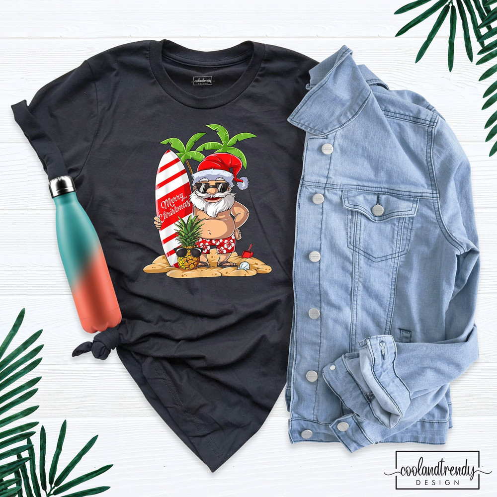 Summer Santa Surf T-Shirt, Christmas In July Shirt, Santa Surfing Shirt, Cute Santa Shirt, Tropical Christmas Shirt, Xmas in July Shirt.jpg
