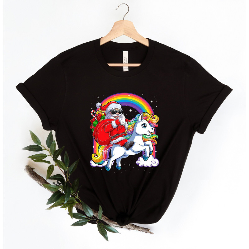 Santa riding a unicorn shirt,  Funny Kids Christmas Shirt, gift for kids Shirt Christmas 2021 Shirt, Cute Xmas shirts, cute  girls gift.jpg