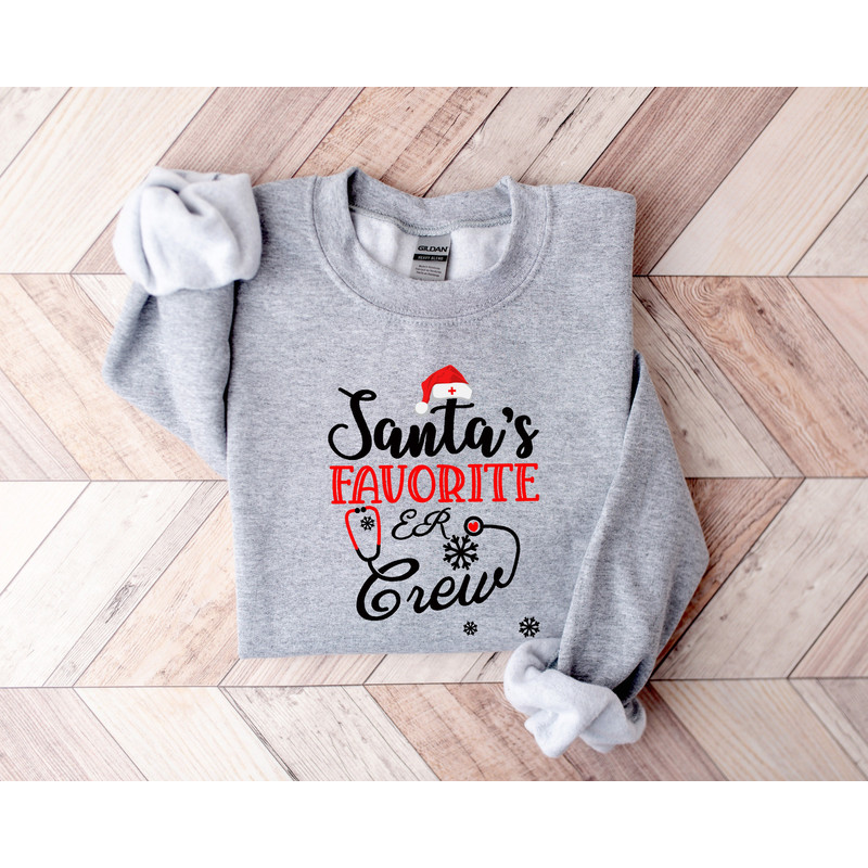 Santa's Favorite ER Crew Long Sleeves Shirt, Christmas Santas ER Crew Shirt Nurse Winter Fashion, Funny Christmas Shirt Gift Nurse RN Shirt.jpg