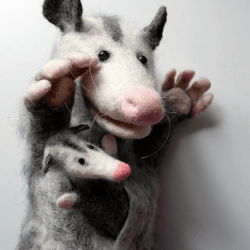 An opossum with a baby in its bag. Natural wool puppets for the puppet theater.