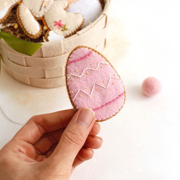 Felt Easter egg cookie in the authors hand