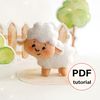 Felt farm animal - cute sheep stands in the background of painted tree and fence