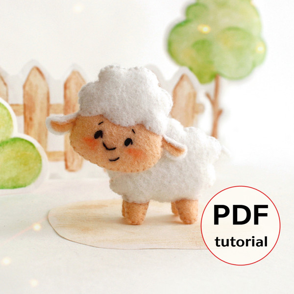 Felt farm animal - cute sheep stands in the background of painted tree and fence
