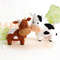 Felt farm animals - cute cows stand in the background of painted tree and fence