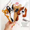 DIY felt hand sewn crafts - kids long Basset hound, corgi and French bulldogs bookmarks in authors hand in front of the opened book