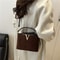 Chic Suede Handbag with V Emblem Elegant and Versatile Top Handle Bag
