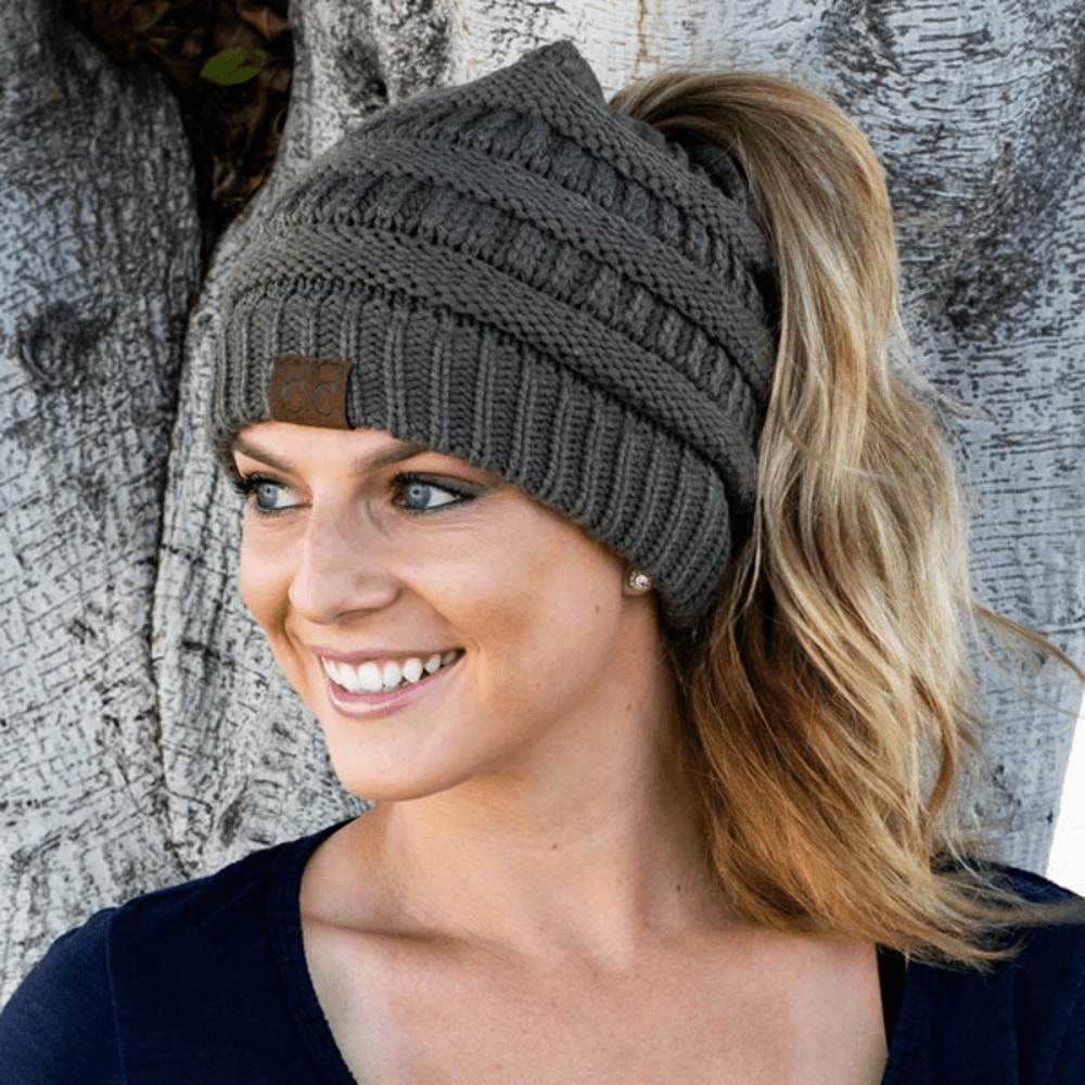 woman wearing a winter ponytail beanie while walking outdoors