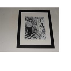 framed elvis presley in a record store 1957