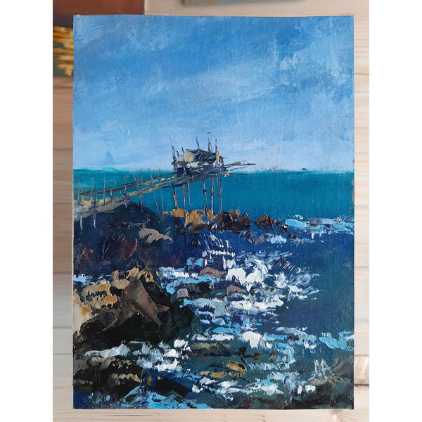 Ocean and rocks art hand painted by artist with palette knife. The brush strokes and clear texture of paint in countless layers are visible to the naked eye.