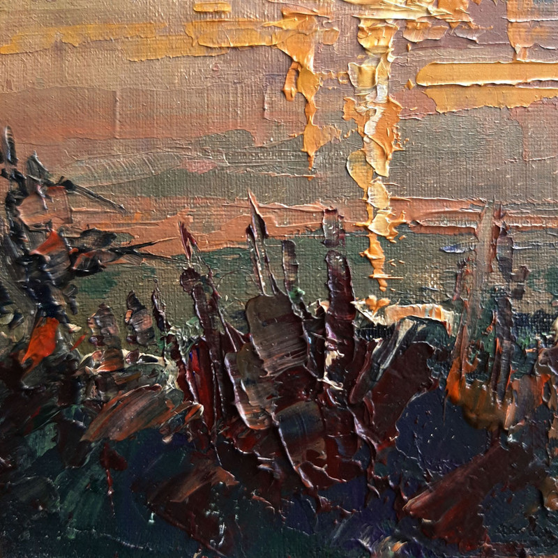 The water, the deep shadows from the trees lining the bank, the peach shades, yellow and orange glare of the setting sun.