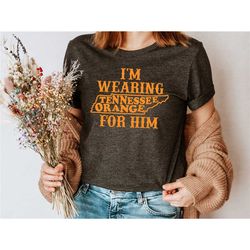 i'm wearing tennessee orange for him shirt, tennessee orange shirt, tennessee shirt, tn shirts, tennessee vols shirt, te