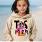 MR-2322024174740-a-young-girl-standing-on-a-beach-wearing-a-hoodie.jpg