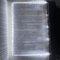 flat panel LED book light illuminating an open book page at night