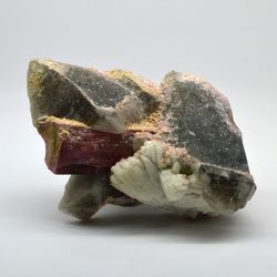 The integration of quartz crystals with tourmaline