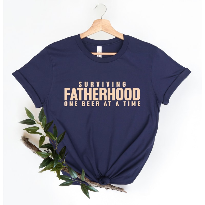 Surviving Fatherhood One Beer at a Time Shirt, Husband Gift, Father's Day Gift, Gift for him, Gift for Dad, New Dad Shirt, Fatherhood, Dad.jpg