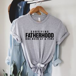 surviving fatherhood one beer at a time shirt, best dad shirt,best dad gift, fathers gift, husband gift, funny dad shirt