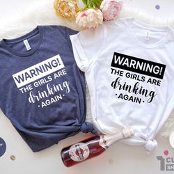 warning the girls are drinking again shirt, girls trip shirts, drinking buddies, best friends shirt, girls night out tee