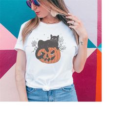 halloween black cat design, black cat on pumpkin shirt, shirt for fall, black cat t-shirt, fall shirt