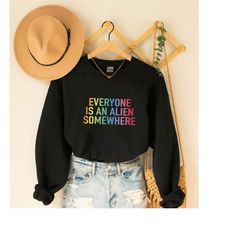 everyone is an alien somewhere sweatshirt, chris martin sweatshirt, jingle bell ball hoodie, equality sweatshirt
