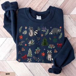 christmas raccoon sweatshirt, evergreen racoon holiday sweater, floral trash panda crewneck, xmas ringtail tee, raccoon