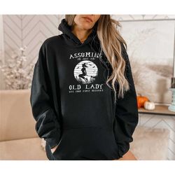 assuming i'm just an old lady was your first mistake halloween hoodie, witch halloween outfit, old lady witch sweater, w