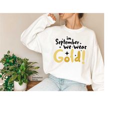 in september we wear gold sweatshirt, childhood cancer awareness hoodie, cancer support gift for support mom, trendy gol