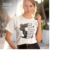 they whispered to her you can't withstand the storm she whispered back i am the storm v-neck shirt positive quote shirt