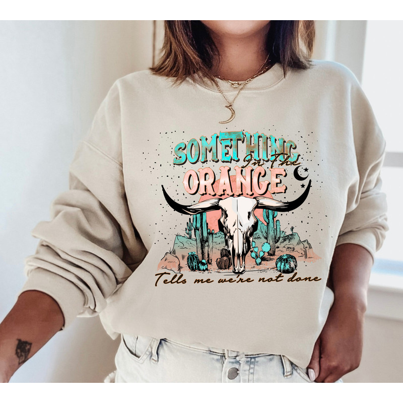 Something In The Orange Sweatshirt, Western Sweatshirt, Country Music, Tells Me We're Not Done,Country Music Sweatshirt,Country Girl Hoodie.jpg