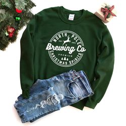 north pole university christmas sweatshirt, christmas gift, north pole brewing co sweatshirt, north pole university, hol