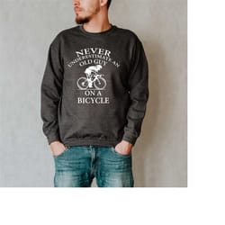 never underestimate an old guy on a bicycle sweatshirt, dad or grandad present, funny cycling gift, cycling grandpa swea