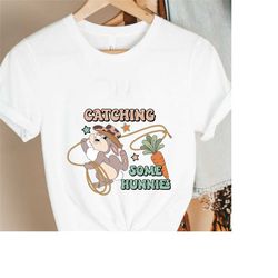 funny easter bunny shirt,howdy easter bunny shirt,cowboy rabbit catching carrot shirt,funny cowboy bunny shirt,western e