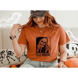 comfort colors stay positive shirt, cute skeleton shirt, funny skull shirt, halloween party shirt, womens halloween gift