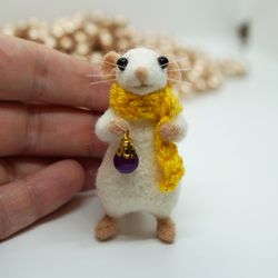 Miniature needle felted mouse with a tiny Christmas bauble