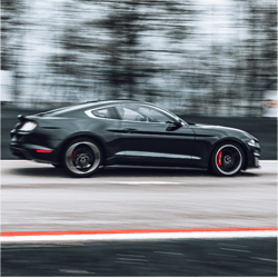 ford mustang bullitt on a racetrack