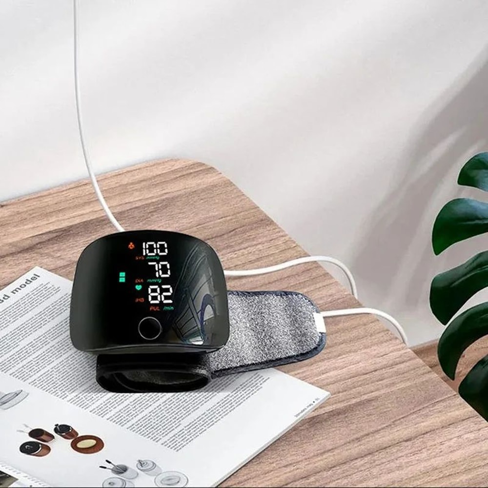 Digital wrist blood pressure monitor on elderly mans arm