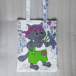 Reusable white tote bag made of eco-friendly cotton canvas, featuring a cat design.