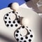 A Pair of Black and White large Polka Dot Hollow Geometric Shape Nostalgia Harbor Wind Earrings