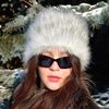 Furry hat in russian style. Gray white fluffy hat. Cute fuzzy winter hat. Slavic girl.